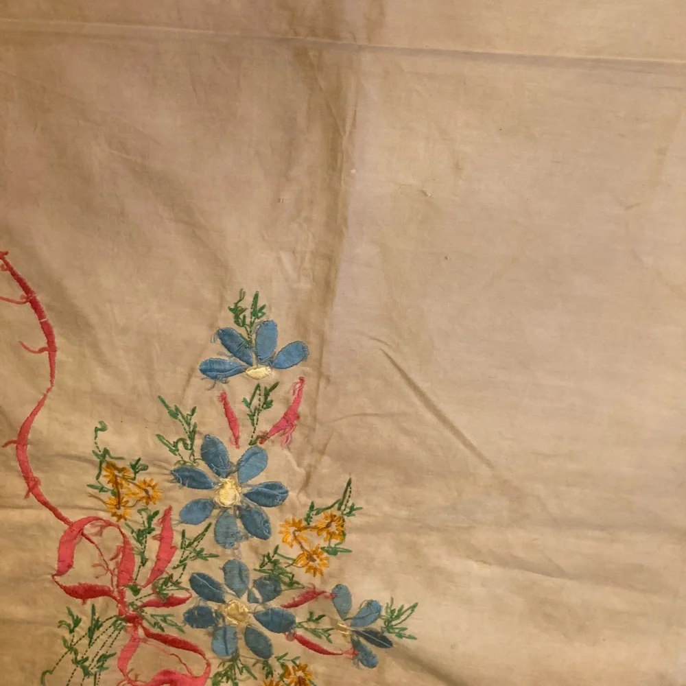 Vintage embroidery muslin, three corners begun, one ink outline blue pink red